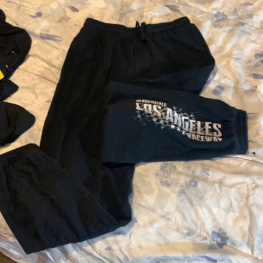 Black aero joggers, w/ white/grey lettering down one leg